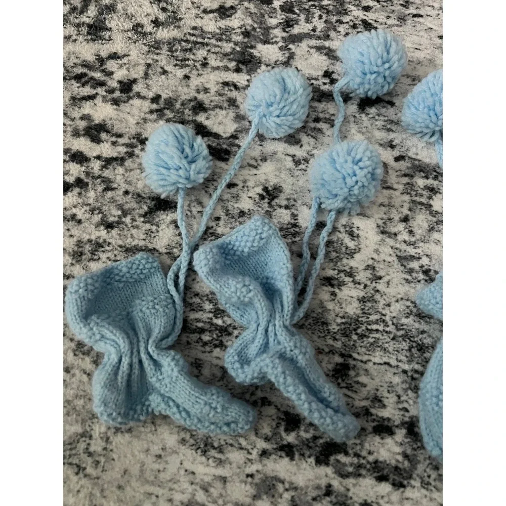 Knitted blue baby mittens and booties